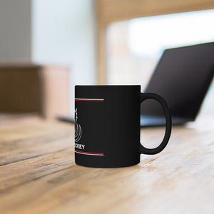 Black coffee mug with the Canadian Blind Hockey logo on the front the mug is infront of a laptop
