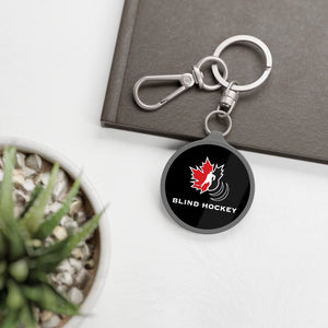 canadian blind hockey keychain on a notepad
